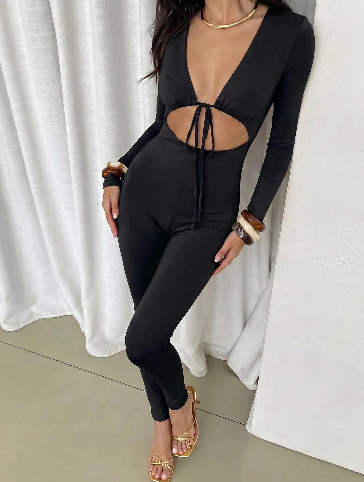 Women's solid color sexy exposed navel lace up hollow long sleeved slim fit jumpsuit