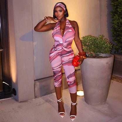Two piece set of tight fitting seven part jumpsuit with deep V-neck print and headband