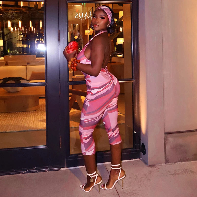 Two piece set of tight fitting seven part jumpsuit with deep V-neck print and headband
