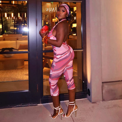 Two piece set of tight fitting seven part jumpsuit with deep V-neck print and headband