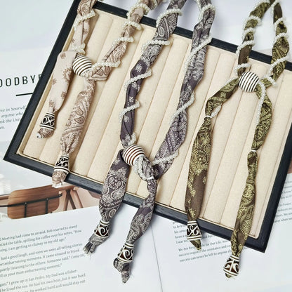 Cashew flower wrapped pearl scarf neck necklace for female artist, unique and beautiful hanging neck accessory, long sweater cha