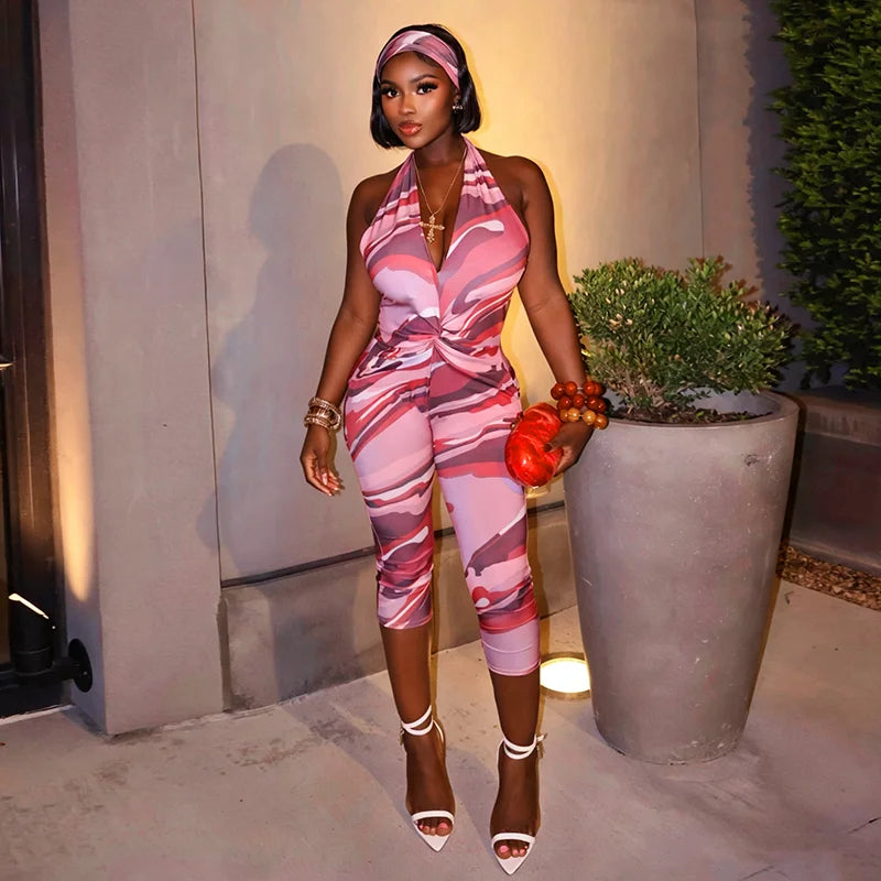 Two piece set of tight fitting seven part jumpsuit with deep V-neck print and headband