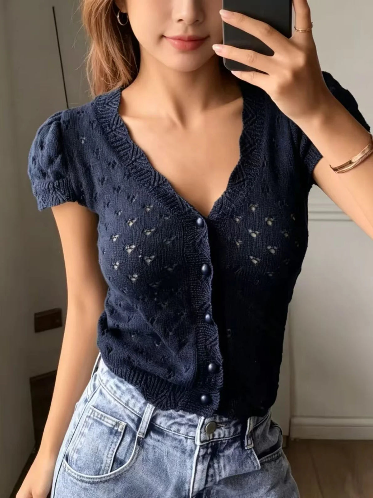 V-neck hollow-out short-sleeved knitted cardigan with single-breasted design, featuring a French vintage and gentle style short