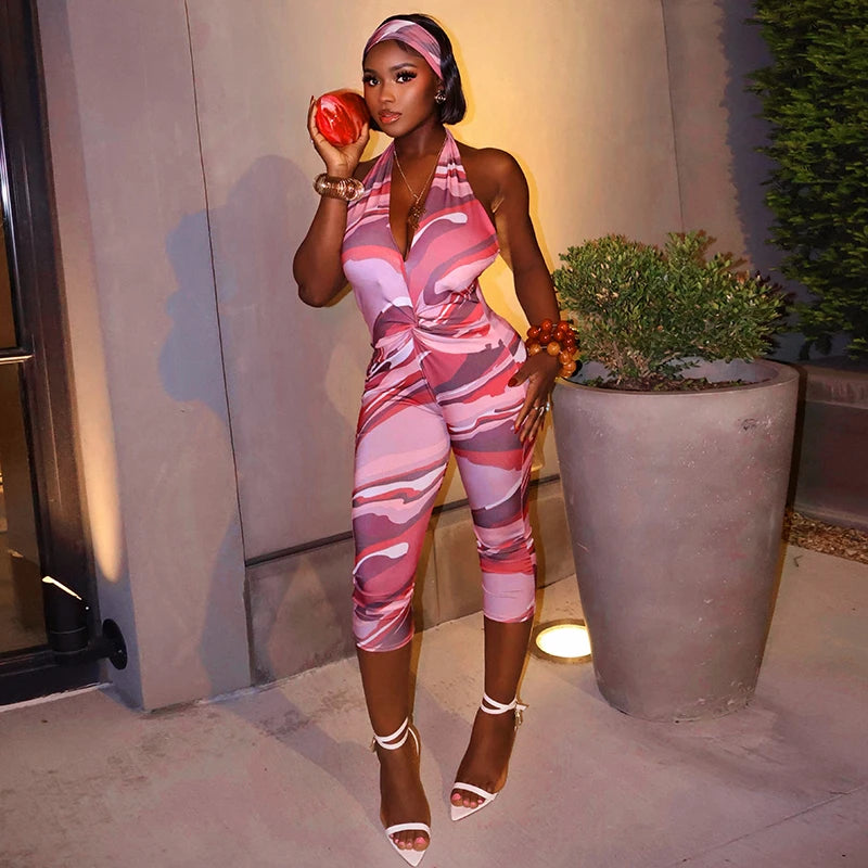 Two piece set of tight fitting seven part jumpsuit with deep V-neck print and headband