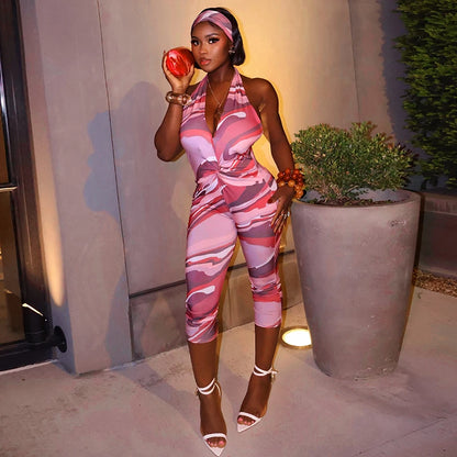 Two piece set of tight fitting seven part jumpsuit with deep V-neck print and headband