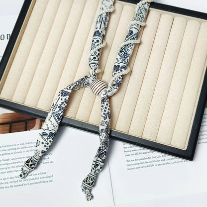 Cashew flower wrapped pearl scarf neck necklace for female artist, unique and beautiful hanging neck accessory, long sweater cha