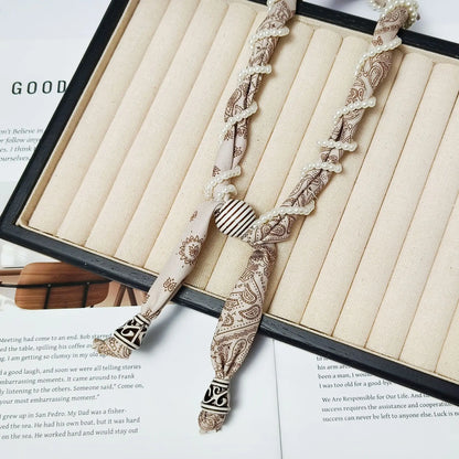 Cashew flower wrapped pearl scarf neck necklace for female artist, unique and beautiful hanging neck accessory, long sweater cha